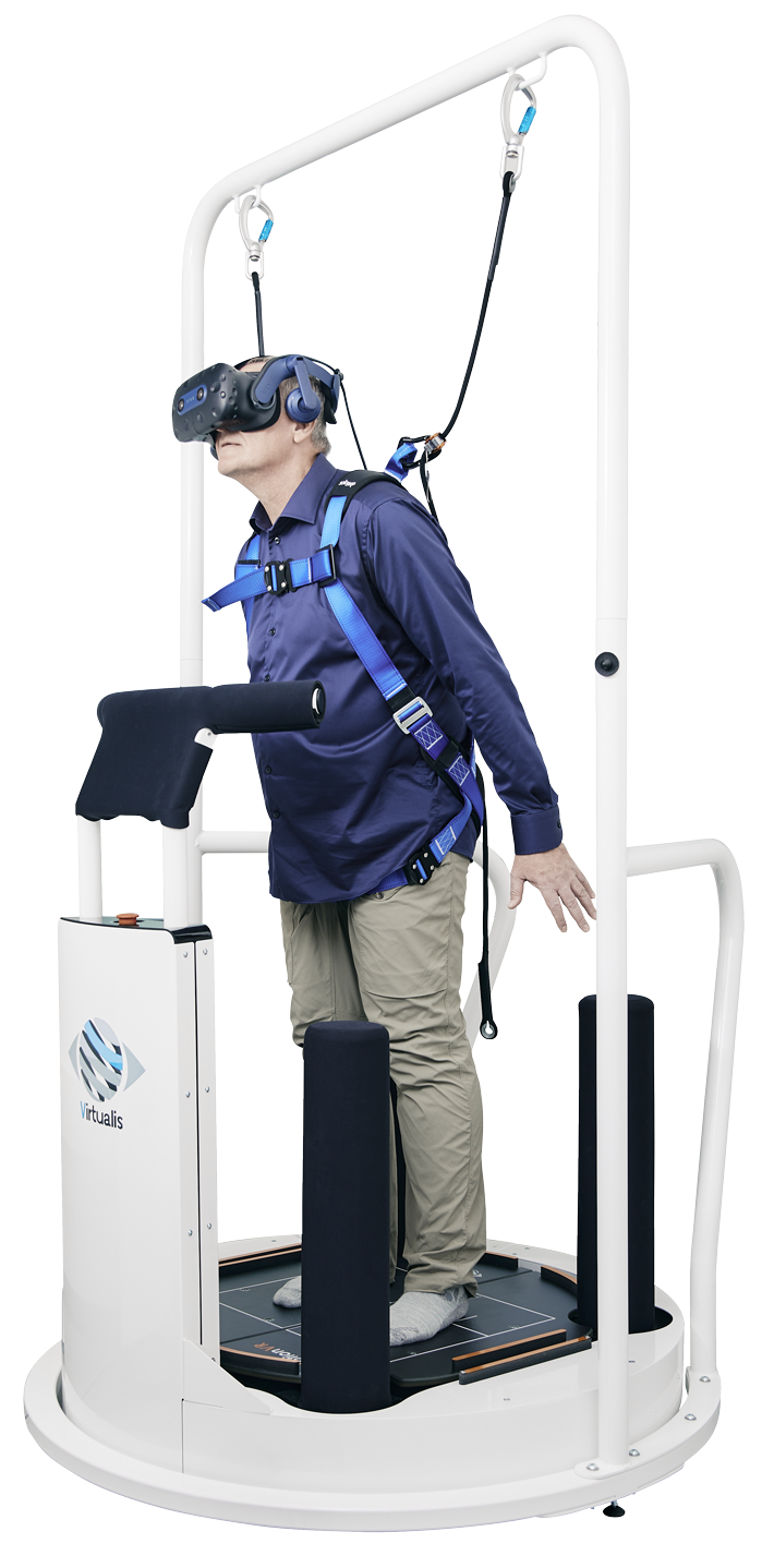 Patient strapped into a harness on the MotionVR system and performing a rehabilitation exercise using VR goggles